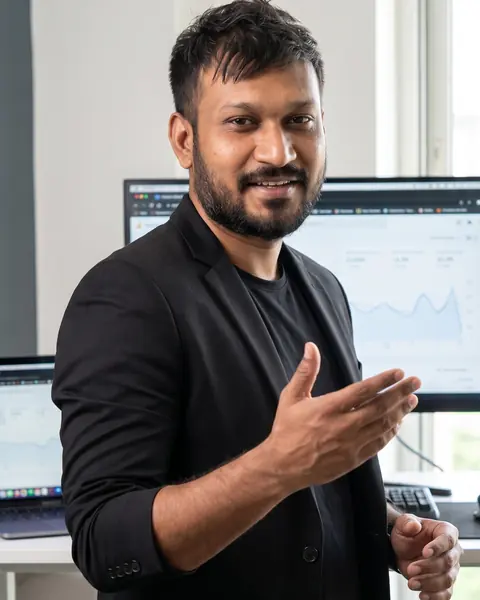Pranav Veerani explaining a marketing strategy in front of analytics screens